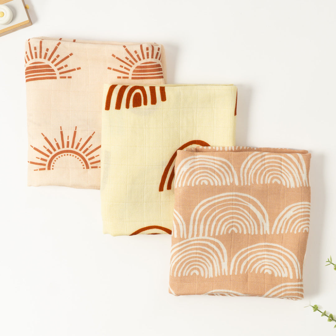 Three bamboo muslin cloths in sun and rainbow prints, peach, lemon and terracotta, folded, set of 3, 60x60cm