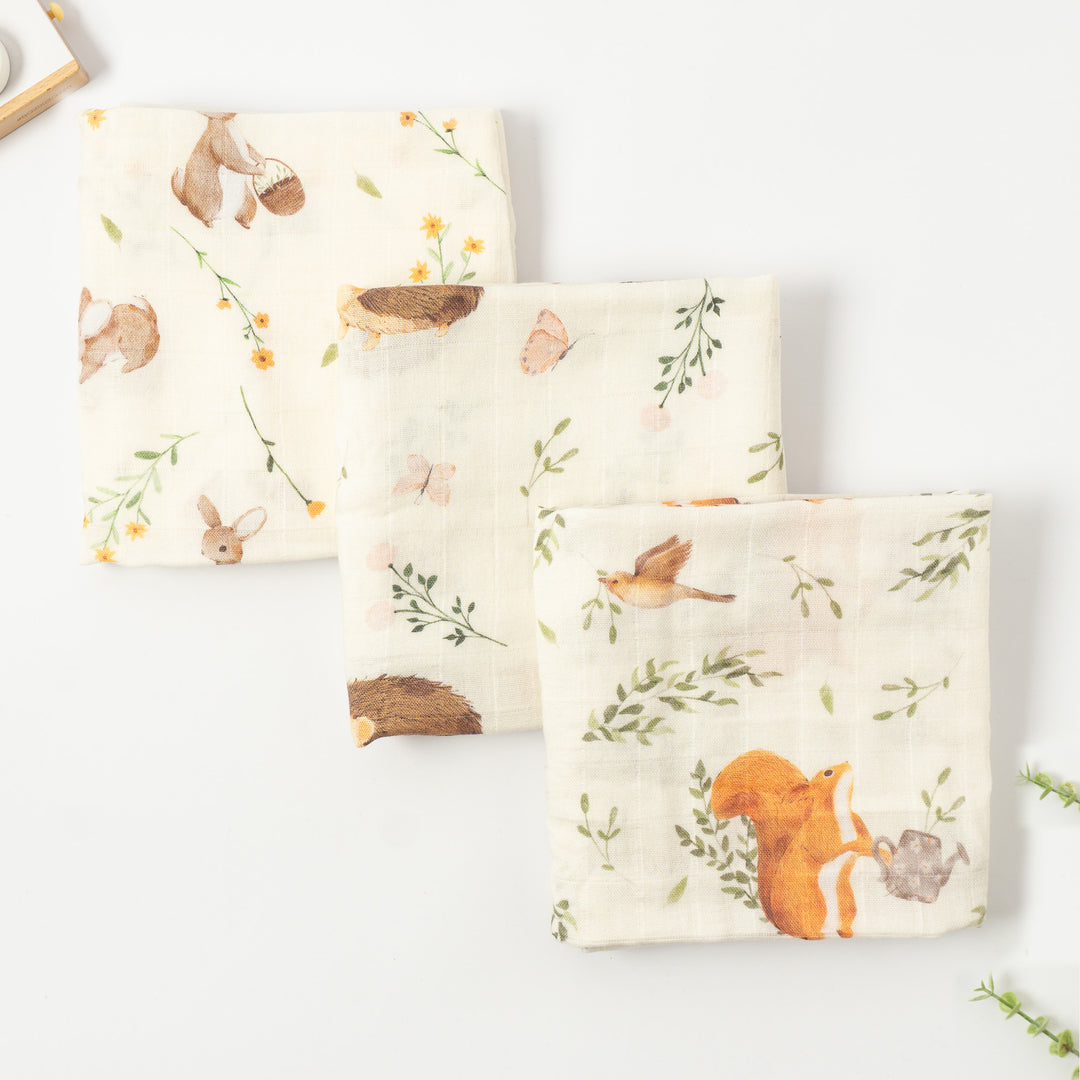 Three bamboo muslin cloths in a woodland animals print with rabbits, hedgehogs and squirrels, folded, set of 3, 60x60cm
